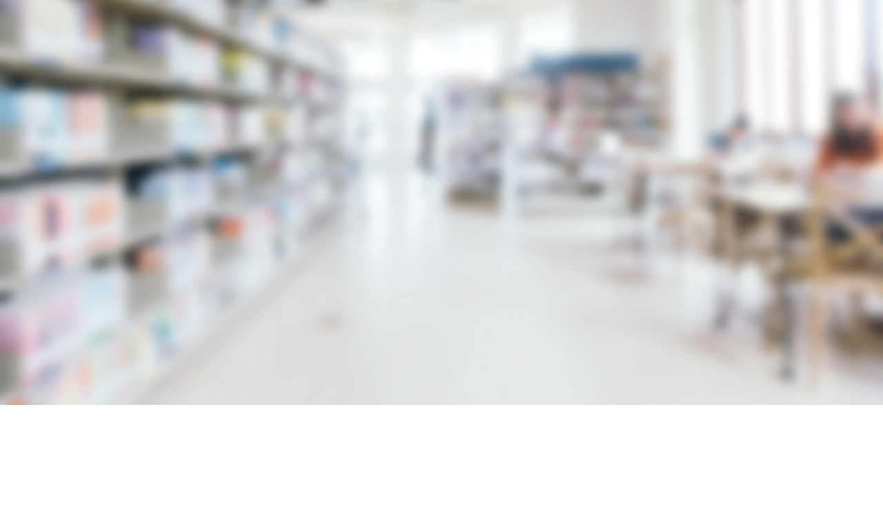 Abstract blur and defocused bookshelf in library interior for background