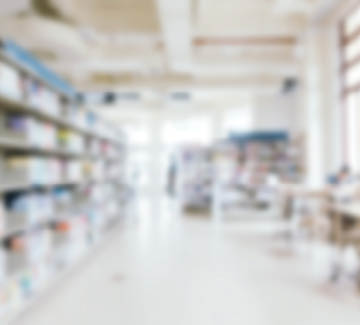 Abstract blur and defocused bookshelf in library interior for background